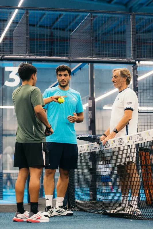 Coach de M3 explicando un ejercicio en la red a los jugadores de la Padel Week